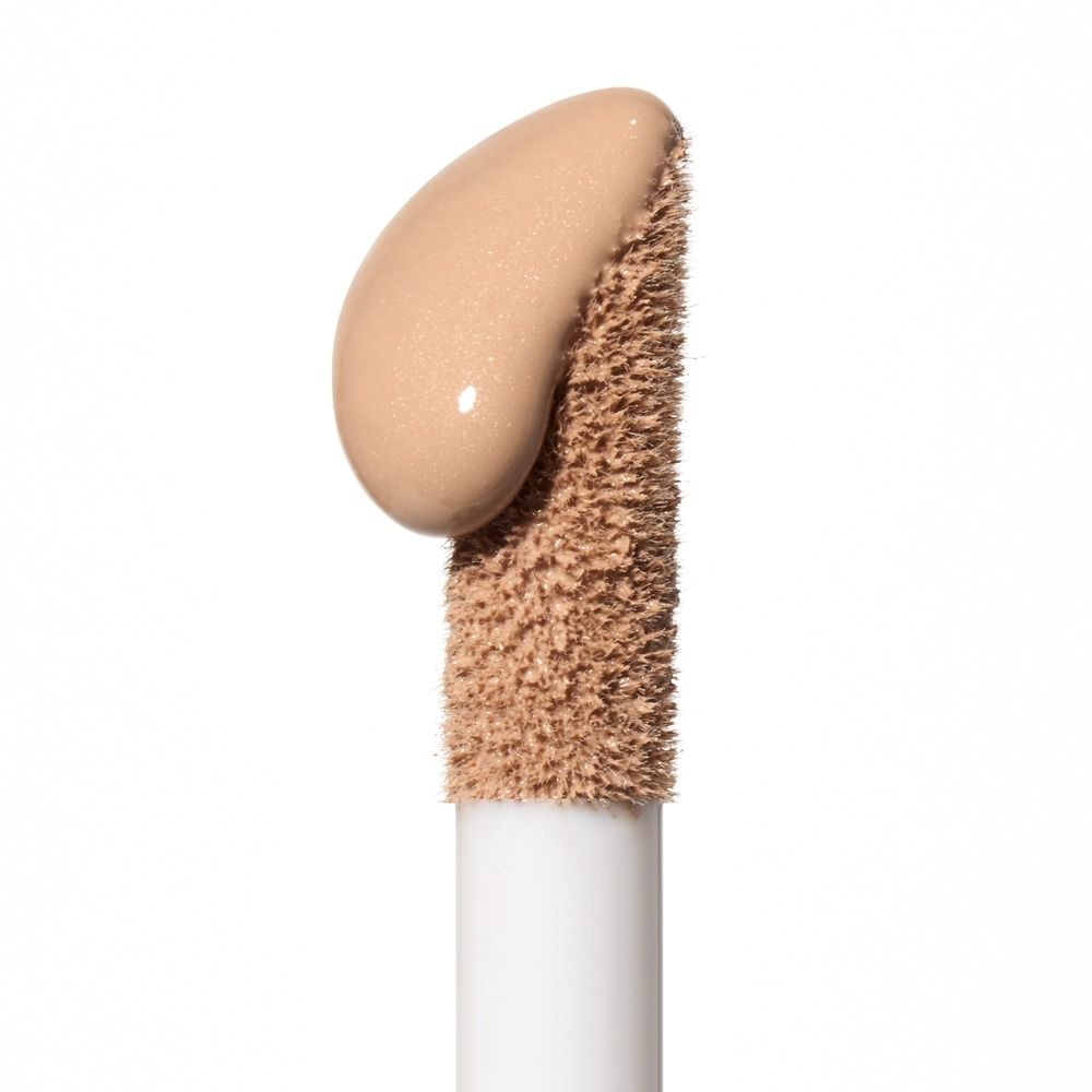 Applikator mit beige flüssigem Concealer